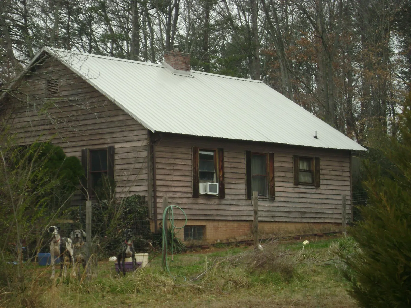 White metal roof on an old wood sided farmhouse, from a Metal Roof Installation job in Marthasville